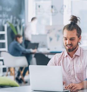 smiling-bearded-corporate-man-using-laptop-2021-08-26-15-44-54-utc.jpg